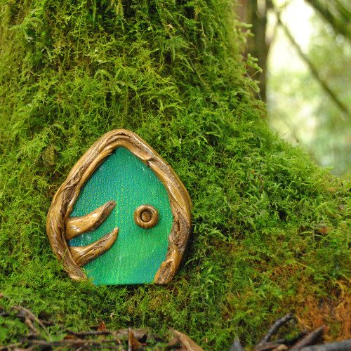 green fairy door with wooden look frame